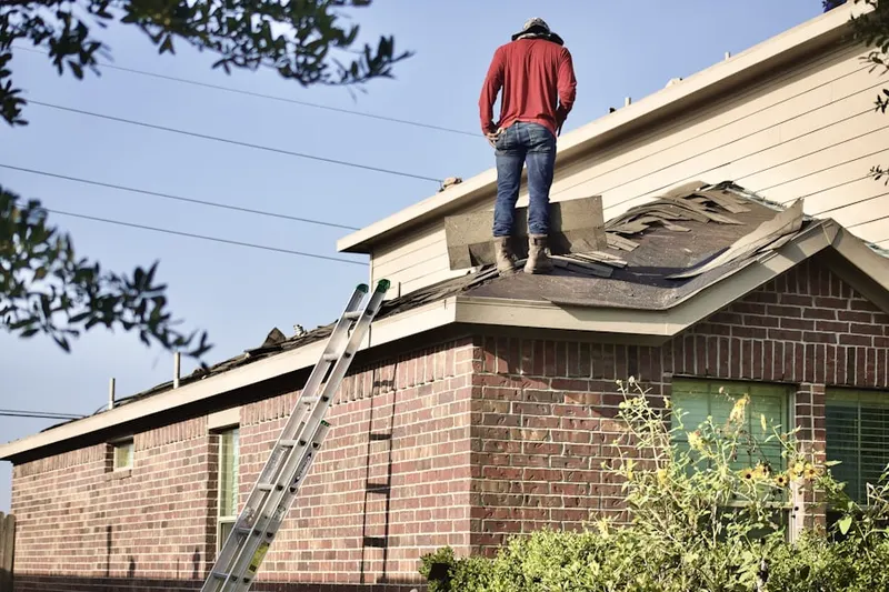 Professional roofer working on a residential roof in Lindenau